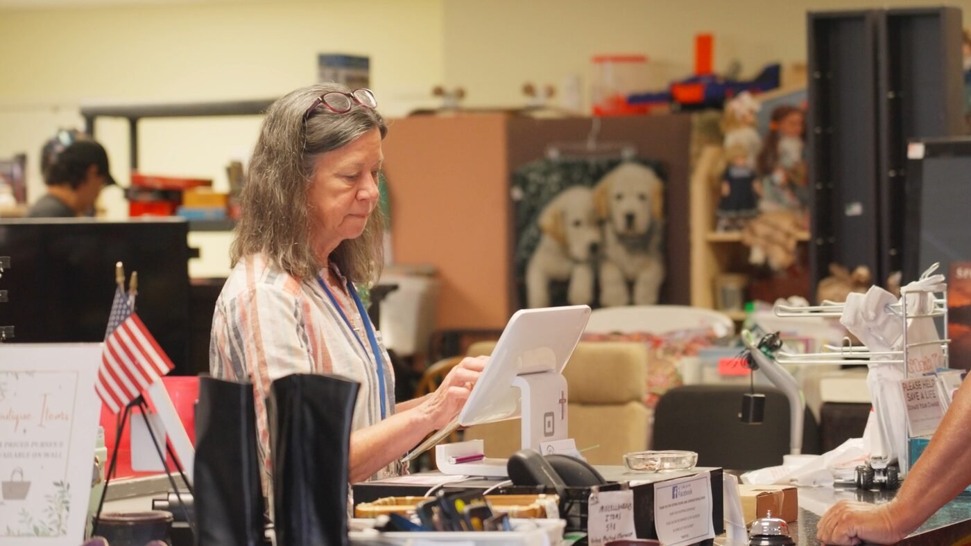 Found and Cherished Resale store owner at checkout — a local Central Florida business