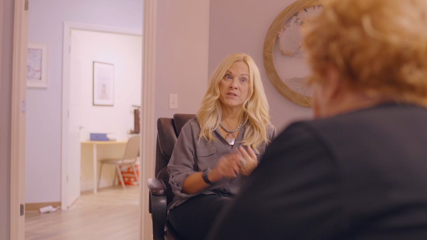 Business owner being interviewed on camera during a professional video shoot